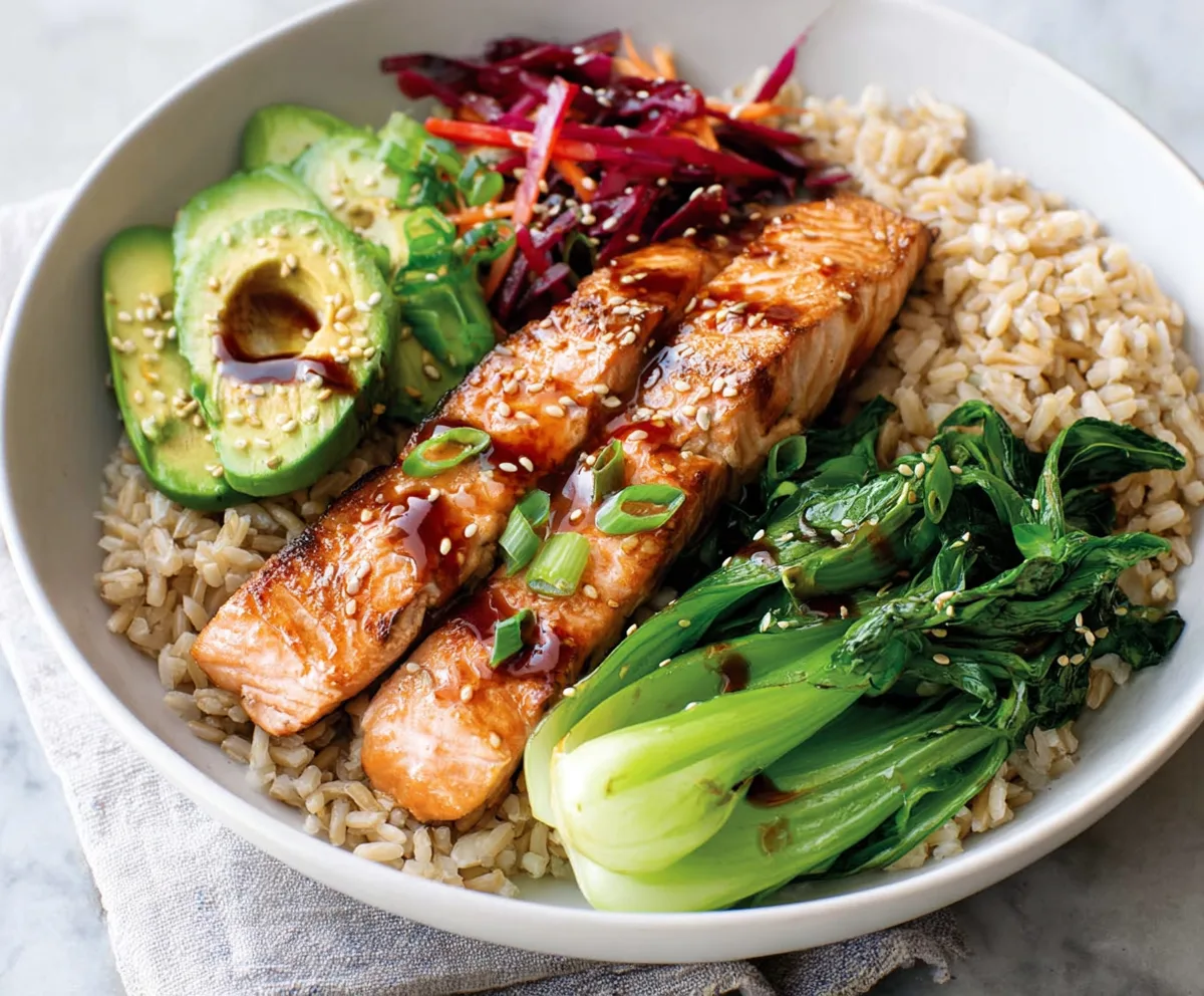 Delicious Teriyaki Salmon Bowl served over fluffy brown rice with fresh vegetables